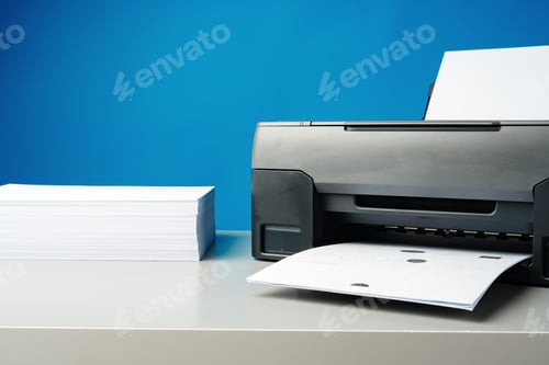 Preview: Laser printer on desk against blue background.
