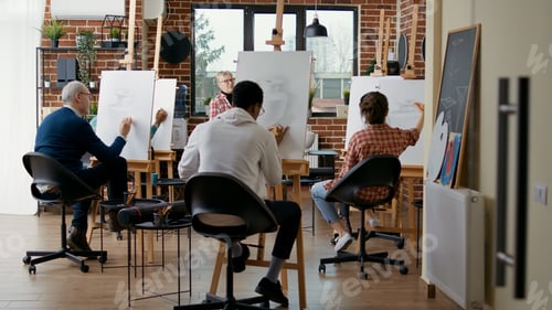 Preview: Senior teacher supervising students to draw vase model on canvas