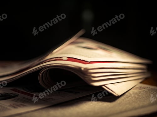 Preview: close up wrinkled newspaper on the table in the dark room