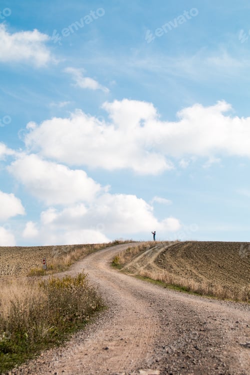Preview: Man staying at the end of road on top of the hill takes photo and enjoying the beautiful view