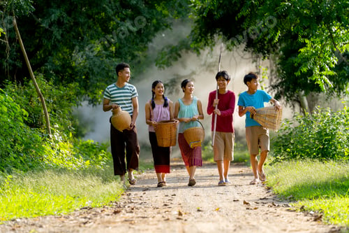 Preview: Group of young Asian girls and boy look like brother, sister and friends walk together on road