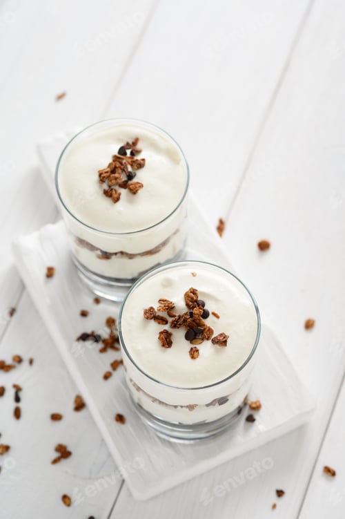 Preview: Greek yogurt with granola in glass jar. Parfait