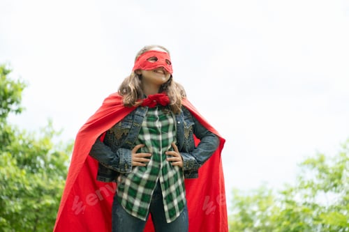 Preview: On a beautiful day in the park, a young girl enjoys her vacation. Playful with a red superhero