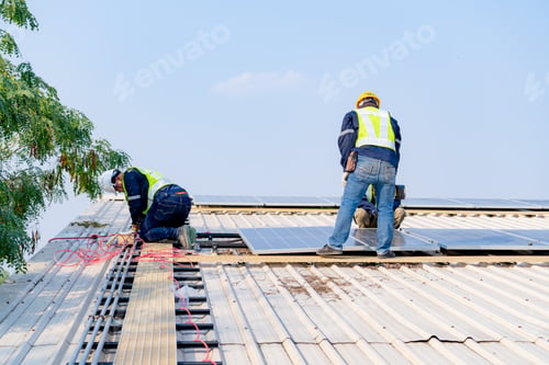 Preview: workers installing solar panels, for efficient energy on rooftop