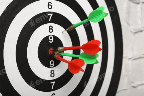 Preview: Arrows hitting dart board on white textured wall, closeup
