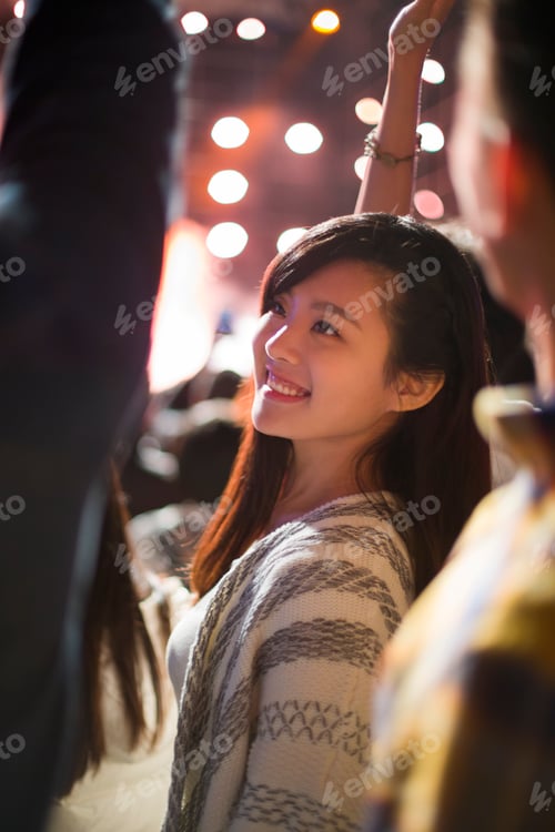 Preview: Happy young woman at music festival