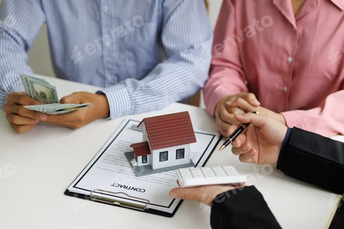 Preview: Banker are discussing a mortgage on a house, land plot and calculating interest real estate loan.