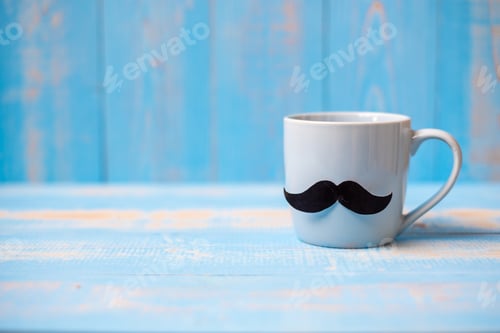 Preview: Blue coffee cup with Black mustache on wood table background in the morning