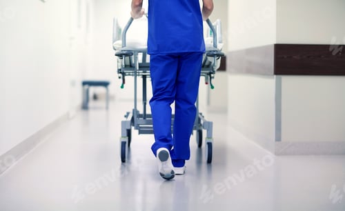 Preview: nurse carrying hospital gurney to emergency room