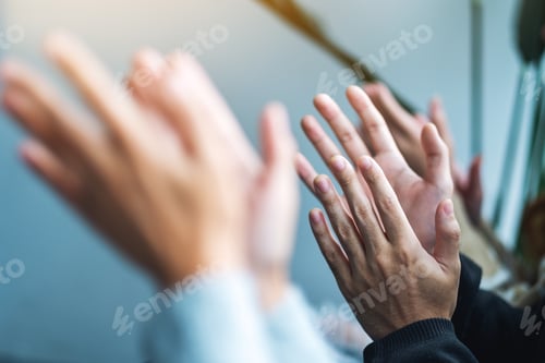 Preview: Closeup image of people clapping hands together