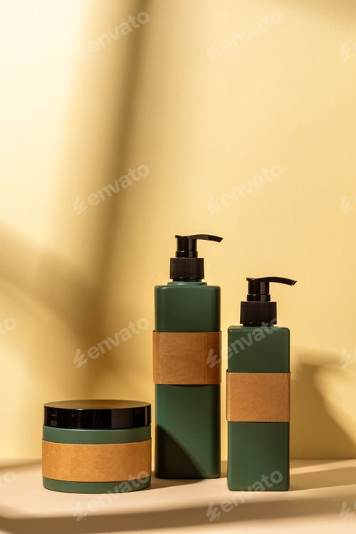 Preview: Dark green plastic bottles for skincare cosmetics on yellow background