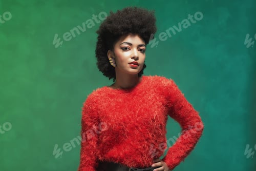 Preview: Half Body Shot Of A Stylish Young Woman With Afro Hair, Wearing Furry Red Shirt And Black Shorts