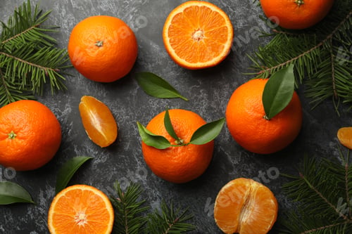 Preview: Mandarins and pine branches on gray smoky background