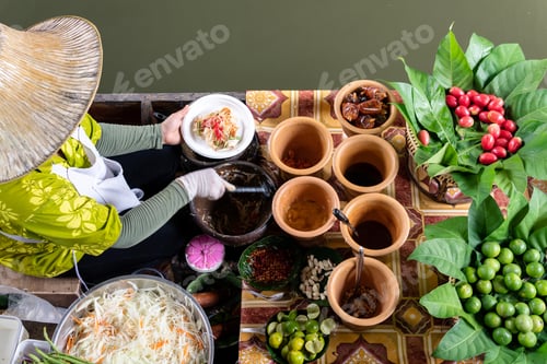 Preview: Market woman in boat cooking food at floating Market in Bangkok, Thailand
