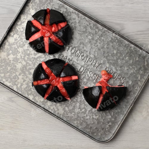Preview: Black Buns with Red Filling on Metal Tray