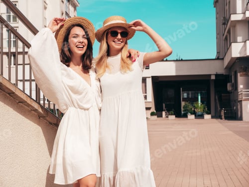 Preview: Two Smiling Women in White Dresses in Urban Setting