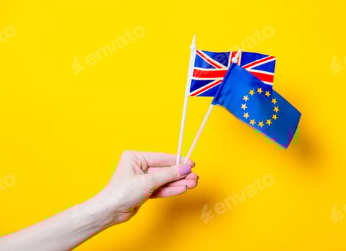 Preview: Female hand holding EU and Great Britain flags