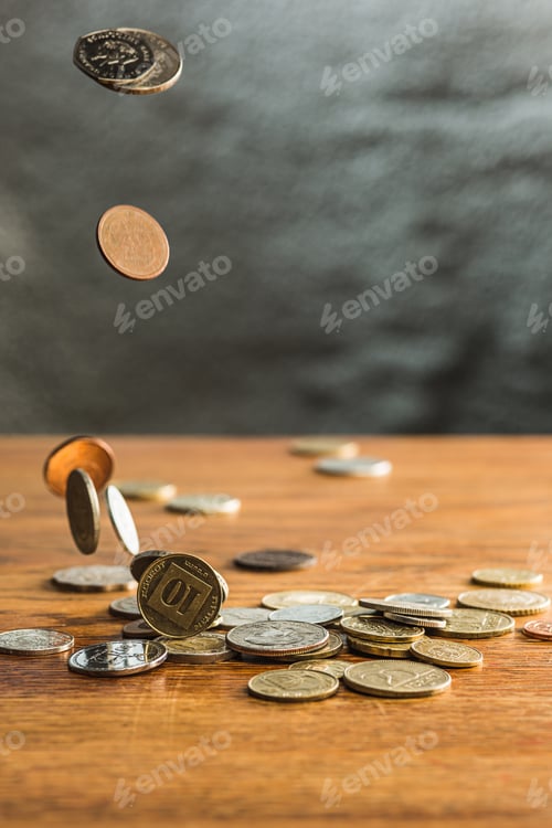 Preview: The silver and golden coins and falling coins on wooden background