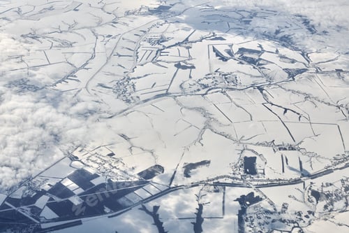 Preview: Aerial view over clouds top to snow covered rivers, fields and roads, winter fresh frosty air