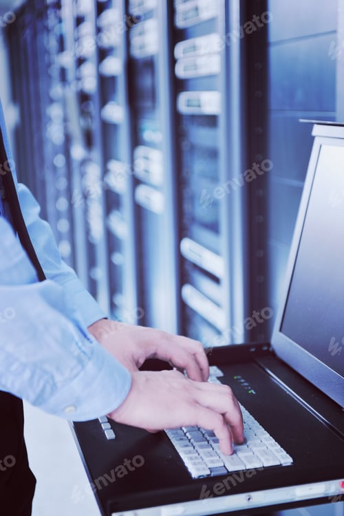 Preview: young it engeneer in datacenter server room