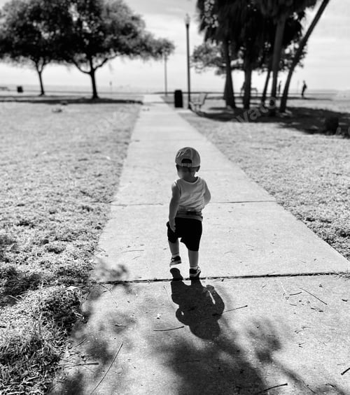 Preview: Little boy walking through park