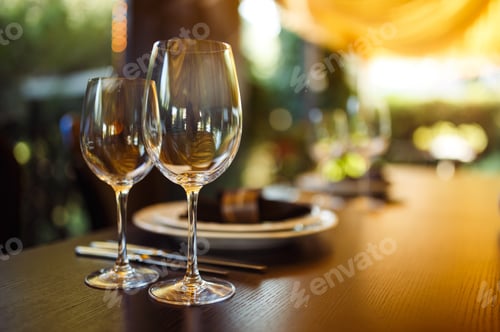 Preview: Sparkling glassware stands on long table prepared for wedding dinner.