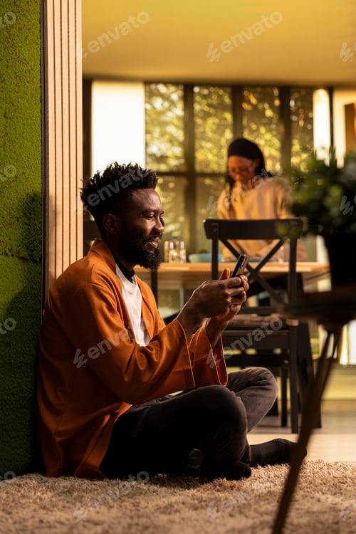 Preview: African american man scrolling through web content on his phone