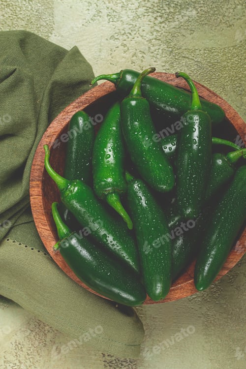Preview: fresh padron pepper, raw, in a wooden bowl, on the table, there are no people.