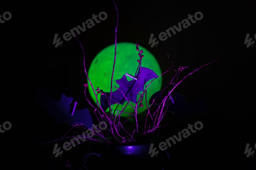 Preview: Cutout bats attached to branches against a moon