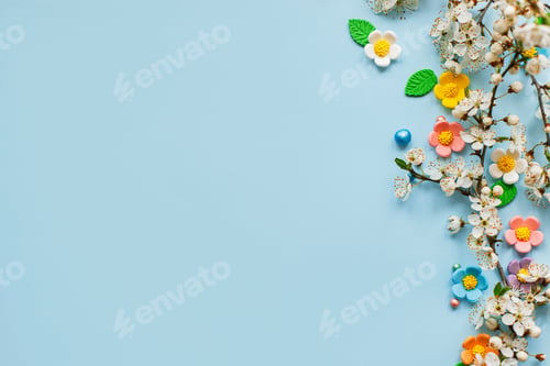 Preview: Stylish colorful candy flowers and cherry blossoms flat lay on blue background