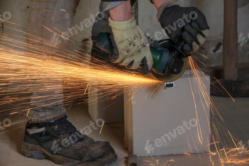 Preview: Man with a grinder working on a piece of steel