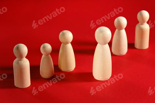 Preview: Concept of leader or boss in a team. Wooden people on red.