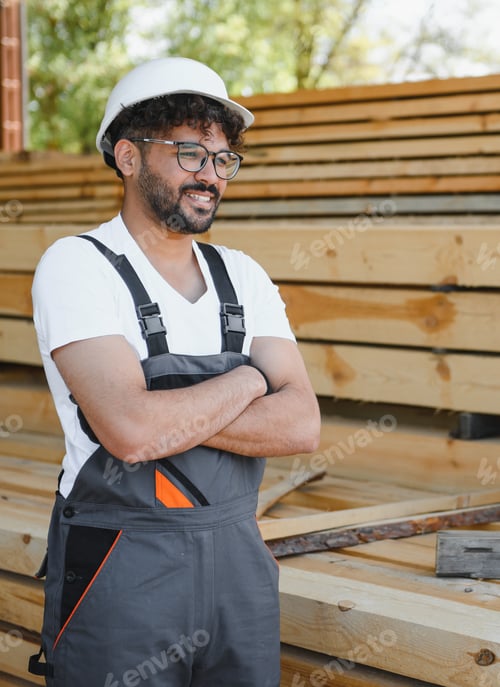 Preview: Woodworker smiling with crossed arms in lumber warehouse