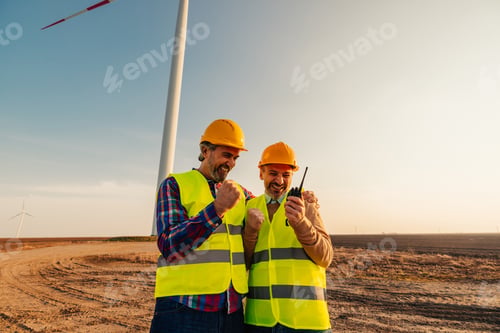 Preview: Wind Turbine middle age mechanical engineers working outdoors