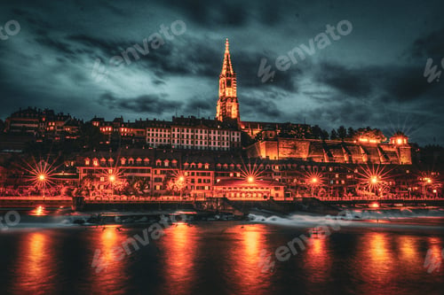 Preview: Night Cityscape along River Illuminated in Orange