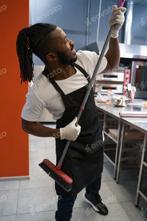 Preview: Funny chef cleaning floor at the restaurant