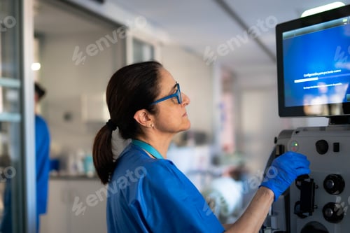 Preview: Medical professional operating advanced equipment in hospital setting