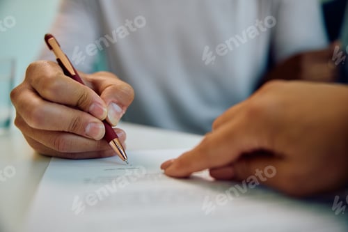 Preview: Close up of man signing paperwork during a meeting with insurance agent in the office.
