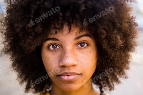 Preview: portrait and close up of beautiful young African or American woman looking at the camera