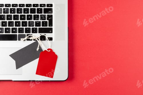Preview: Composition of laptop and gift tags on pink background