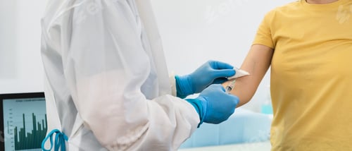 Preview: Doctor doing medical injection syringe vaccine to young patient in hospital