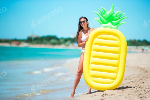 Preview: Young woman in swimsuit on the beach vacation ready to swim