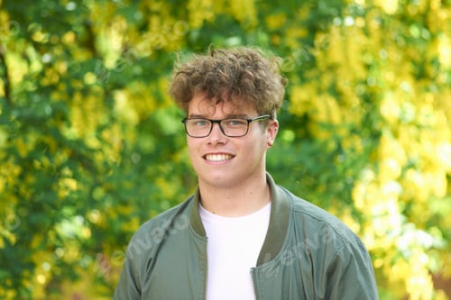 Preview: Portrait of curly haired young man looking at camera smiling