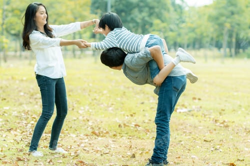 Preview: Happy Asian family spending time together outside in park, vacation of parents concept