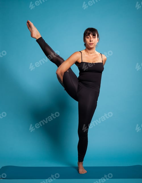 Preview: Personal trainer practicing one leg up yoga pose training body muscles