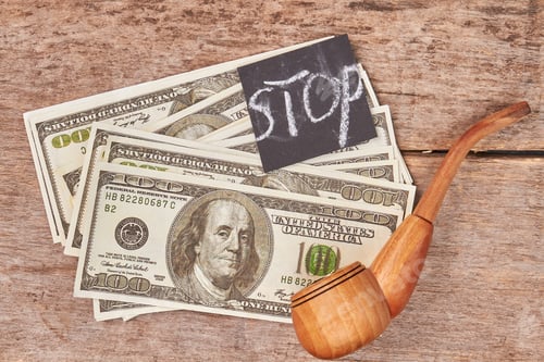 Stop Smoking Concept with Money and Pipe