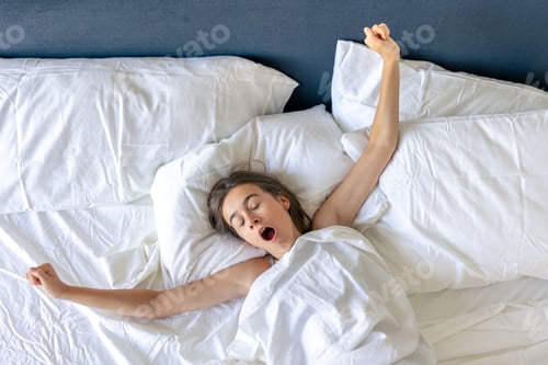 Preview: Girl yawning on pillows close up. Sleepy morning.