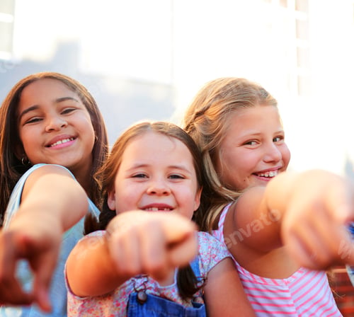 Preview: Its all about you. Portrait of a group of young children pointing together outside.