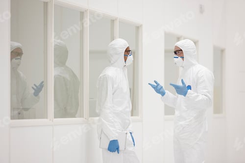 Preview: Scientists Discussing Research Wearing Protective Suits