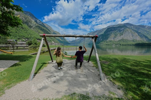 Preview: Couple swinging holding hands at Hallstatt, Austria.